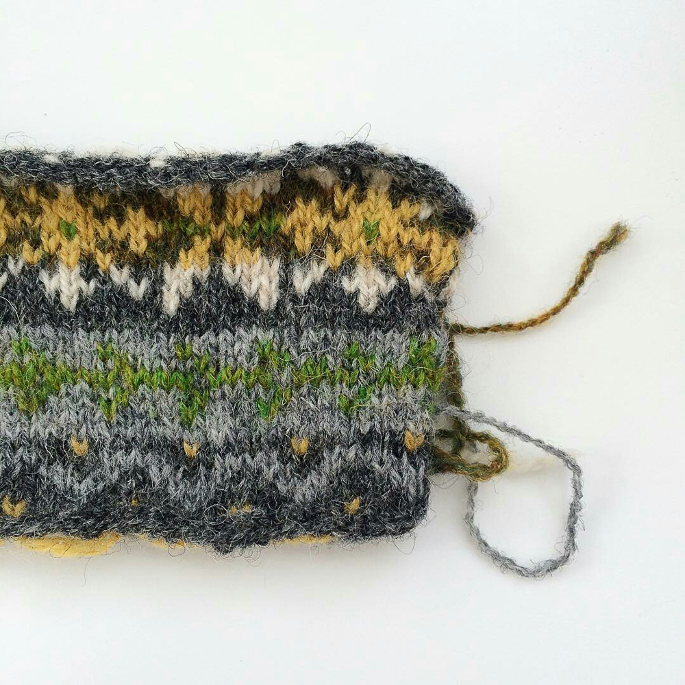 Swatch for my #vestvemberkal Fair Isle vest. I need to work on the colors in the light gray/green stripe, as they're not contrasting enough, but I LOVE that green. I may switch to green background with a white design. #knitting #knit #fairislefriday #fairisleknitting #wool #wovember2015 #projectsweaterchest